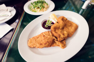 Delicious Wiener Schnitzel served at Brasserie Palmenhaus, a classic Viennese culinary delight.
