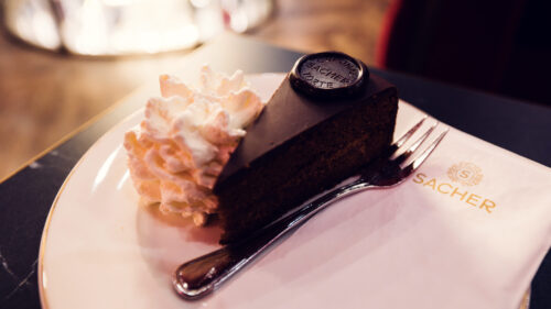 Close-up of the Original Sacher Torte at Café Sacher Bel Étage, showcasing its rich chocolate glaze.