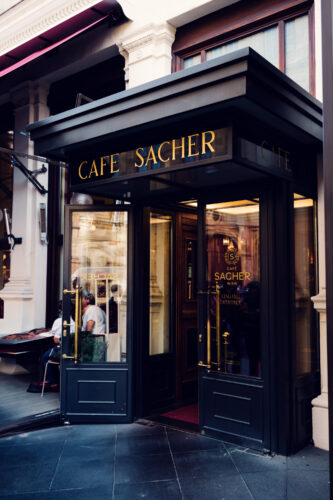 Entrance door to Café Sacher, leading guests into a world of culinary delights.
