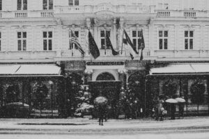 Snow-dusted entrance of Hotel Sacher, inviting visitors to explore its historic halls.