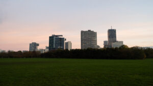 View of Vienna's skyline from Donaupark, blending nature with urban architecture.