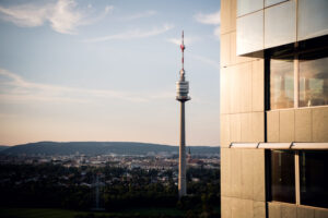 Donauturm Vienna 252 meter television tower against blue sky.