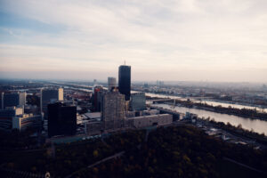 Donauturm Vienna sunset skyscrapers UNO City during golden hour.