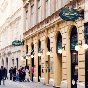 Queue of eager diners waiting outside Figlmüller Bäckerstrasse, testament to its popularity.