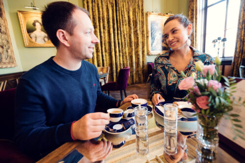 Adriana and Mario enjoying coffee at Gerstner K. u. K. Hofzuckerbäcker, savoring the cozy atmosphere.