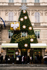 Gerstner K. u. K. Hofzuckerbäcker entrance in Vienna, adorned with festive decorations during winter.