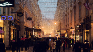 Twinkling Christmas lights and decorations on Kohlmarkt street, adding a festive charm to Vienna's winter scene.