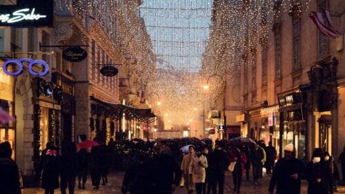 Twinkling Christmas lights and decorations on Kohlmarkt street, adding a festive charm to Vienna's winter scene.