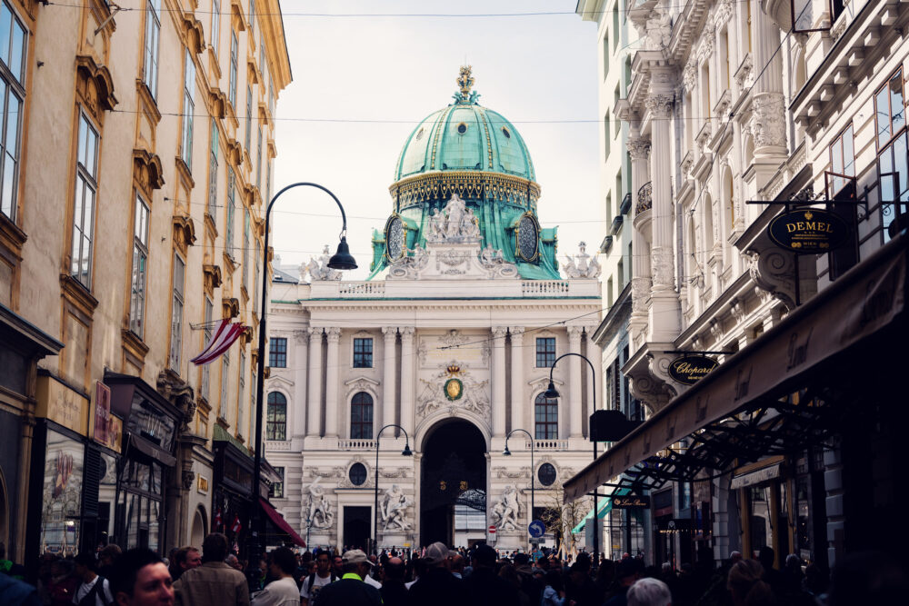 Kohlmarkt's luxury shopping scene with Hofburg backdrop.