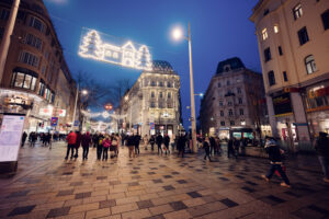 Christmas time on Mariahilfer Strasse Vienna showing holiday window displays festive decorations and Christmas shopping crowds Vienna Austria.