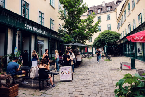 Historic alleyway of Raimundhof with small shops and cafés.