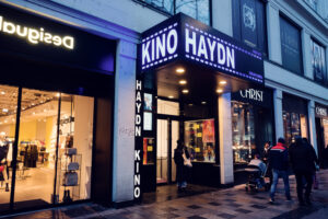 Haydn Kino cinema entrance Mariahilfer Strasse Vienna at night with illuminated movie theater signage.