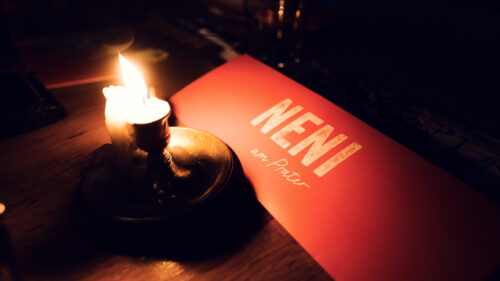 Warm candlelight setting at Neni am Prater, creating an intimate and cozy dining experience.