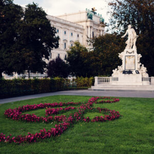 Mozart Monument surrounded by blooming flowers in Burggarten, a popular spot for music enthusiasts and tourists.