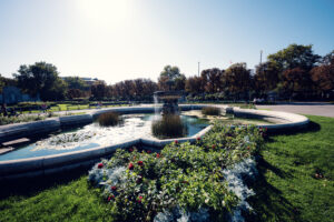 Volksgarten Vienna fountain surrounded by colorful flower beds and pathways.