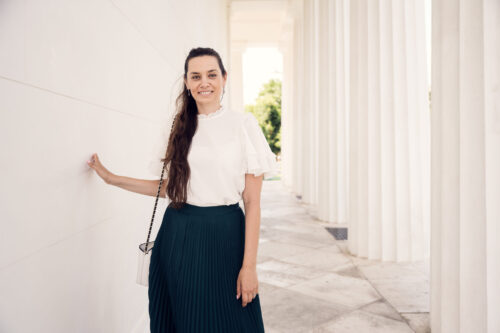 Adriana at Theseustemple Vienna with neoclassical Greek columns and white marble architecture backdrop.