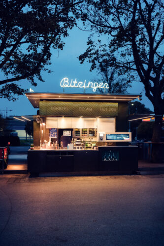 Inviting atmosphere at Bitzinger Würstelstand, where locals and tourists gather to enjoy Vienna's famous sausages.