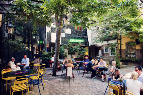 Charming garden at Café Friedlich, offering a peaceful oasis in Vienna's urban landscape.