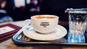 Traditional Café Melange at historic Hawelka, served in original porcelain cup with perfect milk foam crown.