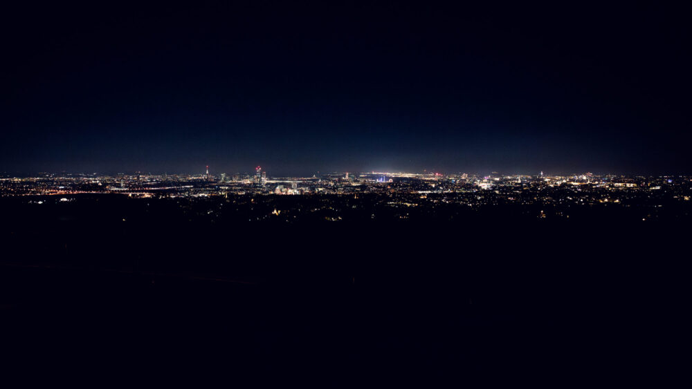 Twinkling city lights of Vienna from Cobenzl, creating a magical nighttime panorama.