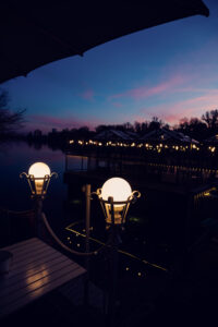 Sunset dining at Das Bootshaus terrace, where contemporary design meets nature's evening show.