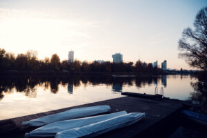 Elegant wooden pier extending into the Old Danube, framing Das Bootshaus against Vienna's skyline.