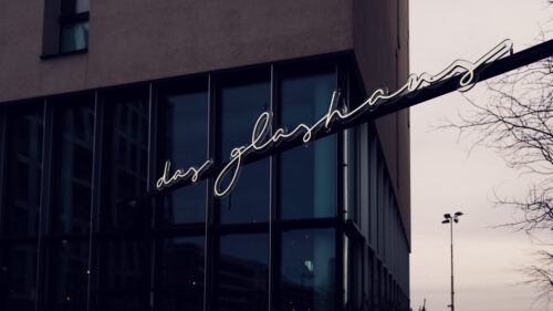 Modern glass facade of Das Glashaus Vienna.