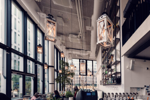 Light-filled corner at Das Glashaus, where vintage elements contrast with modern design.