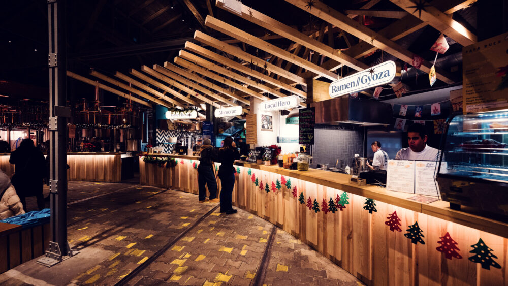 Open kitchen at Gleis//Garten, where culinary artistry meets industrial charm.