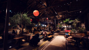 Preserved railway tracks integrated into modern flooring, showcasing thoughtful architectural preservation at Gleis//Garten.