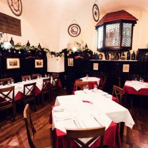 Cozy interior of Griechenbeisl, featuring original wooden beams and historic decor.