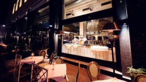 Meissl & Schadn's schnitzel show kitchen seen through the grand windows facing Ringstrasse.