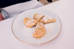 Homemade plum turnovers (Powidltascherl) with vanilla sauce, a sweet classic reinterpreted at Meissl & Schadn.