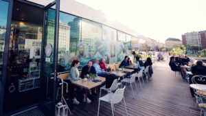 Stylish outdoor seating at Motto am Fluss, where urban design meets waterfront ambiance.