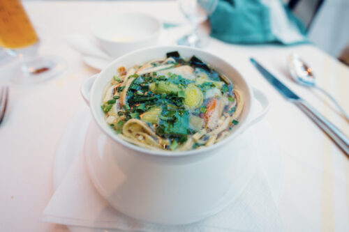 Classic Frittatensuppe at Plachutta Wollzeile, where thin sliced pancake strips float in crystal-clear beef broth, demonstrating quintessential Viennese soup tradition.