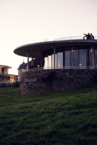 Evening light illuminating Rondell Café's curved facade.