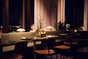 Elegant Art Deco details inside Rondell Café, where vintage chandeliers cast warm light on traditional coffee house tables.