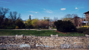 Wienfluss waterway through Stadtpark, featuring original 19th-century stone embankments and bridges.