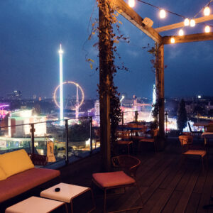 ZOKU's rooftop at twilight, when string lights create a magical atmosphere above Vienna's rooftops.