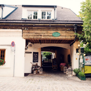 Historic entrance to Heuriger Zum Martin Sepp, where traditional 'Ausg'steckt' sign welcomes visitors to this authentic Viennese wine tavern.