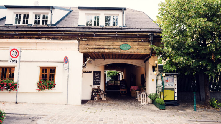 Historic entrance to Heuriger Zum Martin Sepp, where traditional 'Ausg'steckt' sign welcomes visitors to this authentic Viennese wine tavern.