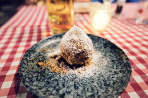 House-made Marillenknödel at Martin Sepp dusted with sweet breadcrumbs, capturing Vienna's beloved summer dessert.