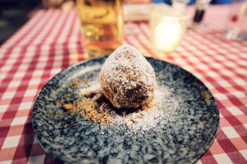 House-made Marillenknödel at Martin Sepp dusted with sweet breadcrumbs, capturing Vienna's beloved summer dessert.