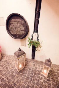 Charming courtyard entrance at Martin Sepp, decorated with seasonal grape vines and traditional lanterns.