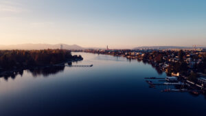 Alte Donau river at sunset in Vienna with warm evening light reflecting on calm water surface.