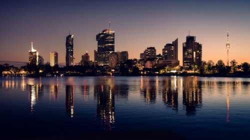 Vienna skyline during golden hour from Alte Donau recreational zone.