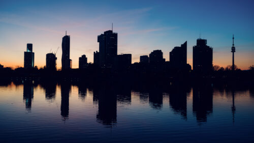 Vienna city skyline during golden hour from Alte Donau recreational area.