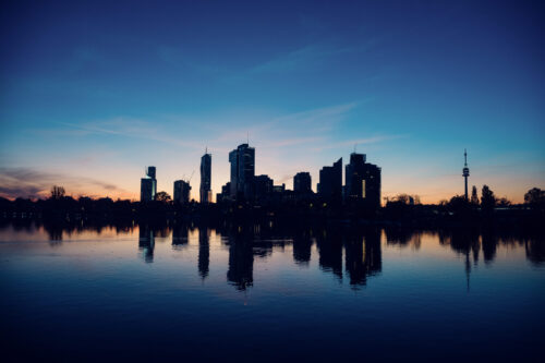 Evening sunset panorama of Vienna skyline from Alte Donau.