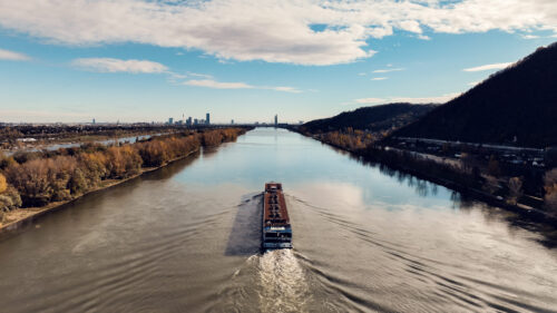 Vienna Danube River boat tour vessel navigating historic waterway.