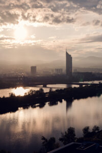 Sunset at Donauinsel Vienna with golden hour lighting over Danube River and 21-kilometer artificial island recreational area.